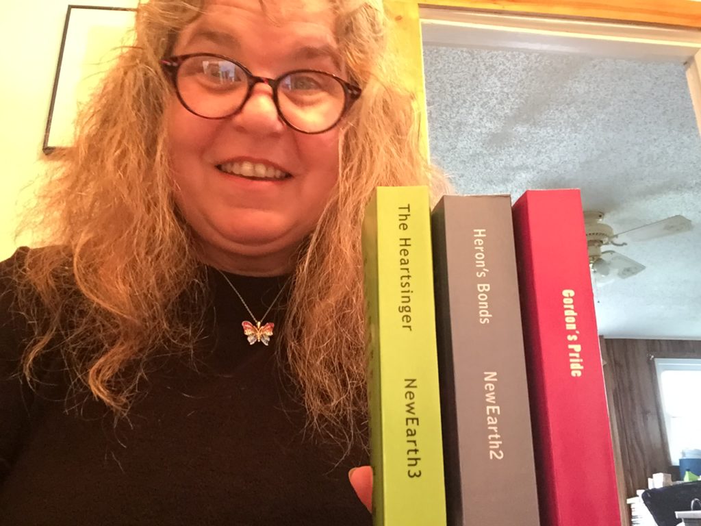 Julia with the first three books in the NewEarth series